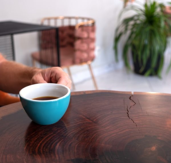 A,Man,Sitting,By,The,Table,In,A,Cafe,And